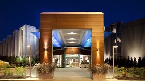 A modern hotel entrance with a prominent sign, a glass door, and a well-lit facade. - Weber's Hotel & Restaurant (Ann Arbor)
