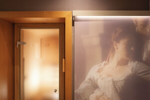 Uma porta de madeira com um painel de vidro fosco e um acessório de iluminação acima.