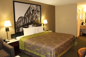 A hotel room with a large bed, two bedside lamps, a telephone, a chair, and a wall-mounted picture. - Super 8 by Wyndham Bossier City/Shreveport Area (Bossier City)