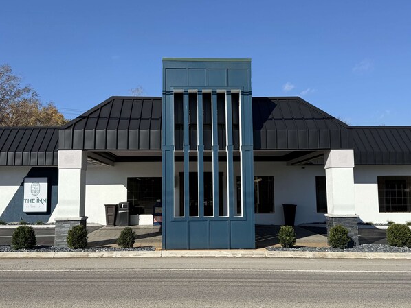 A modern hotel with a prominent entrance, a sign reading "The Inn at Tree City," and a well-maintained exterior.