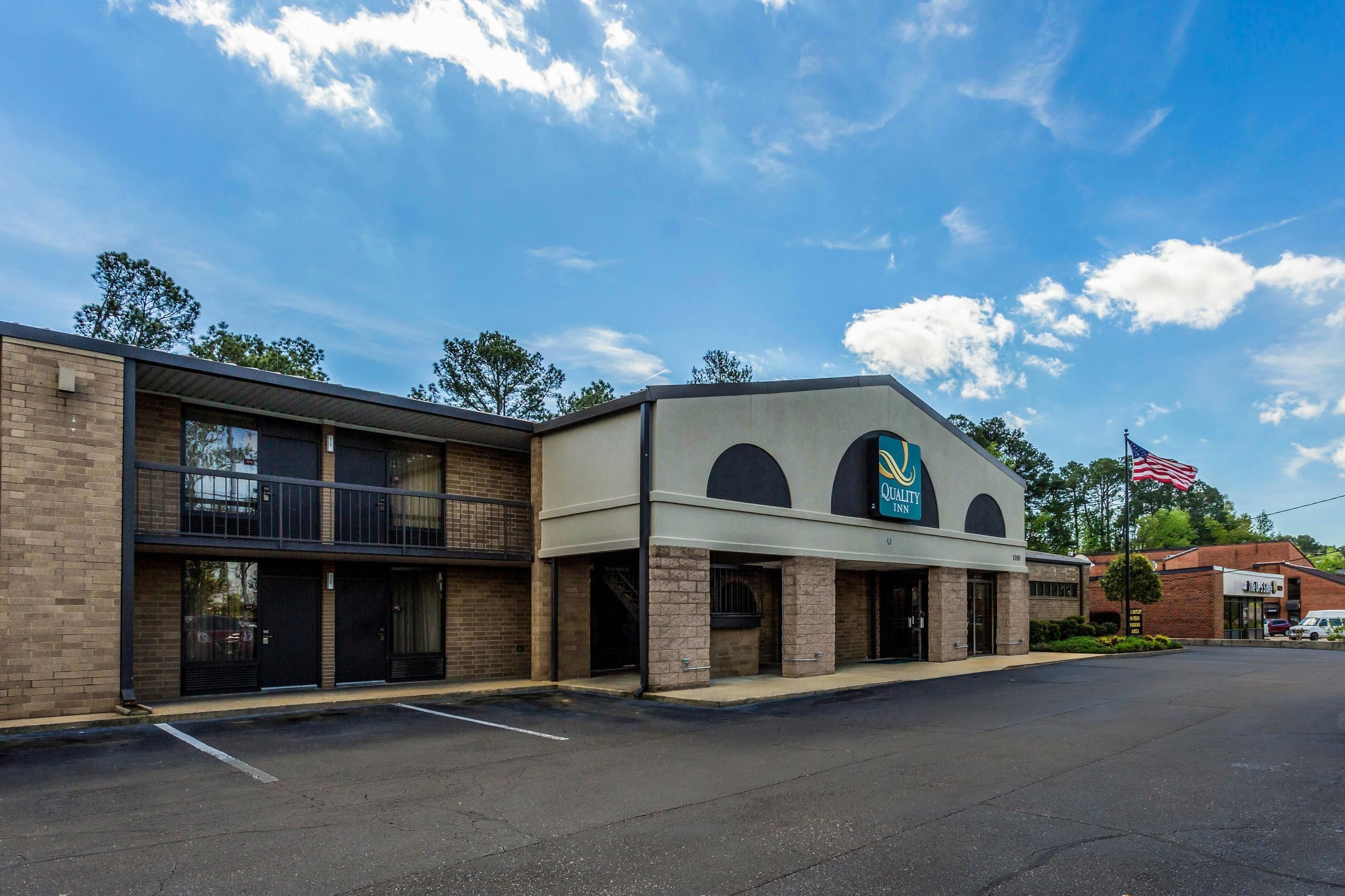 A two-story building with a parking lot in front.
