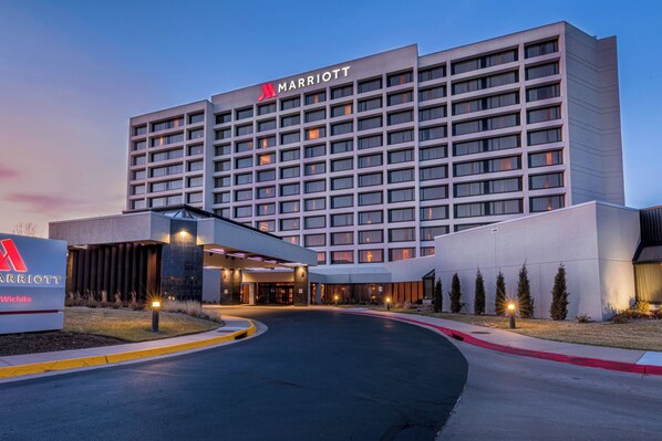 A Marriott hotel with a modern design, featuring a large entrance and a well-lit facade.