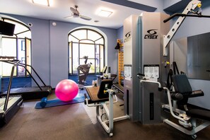 Stay fit on the go with our fully equipped gym featuring treadmills, a stationary bike, and weight machine.