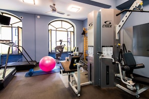 Stay fit on the go with our fully equipped gym featuring treadmills, a stationary bike, and weight machine.