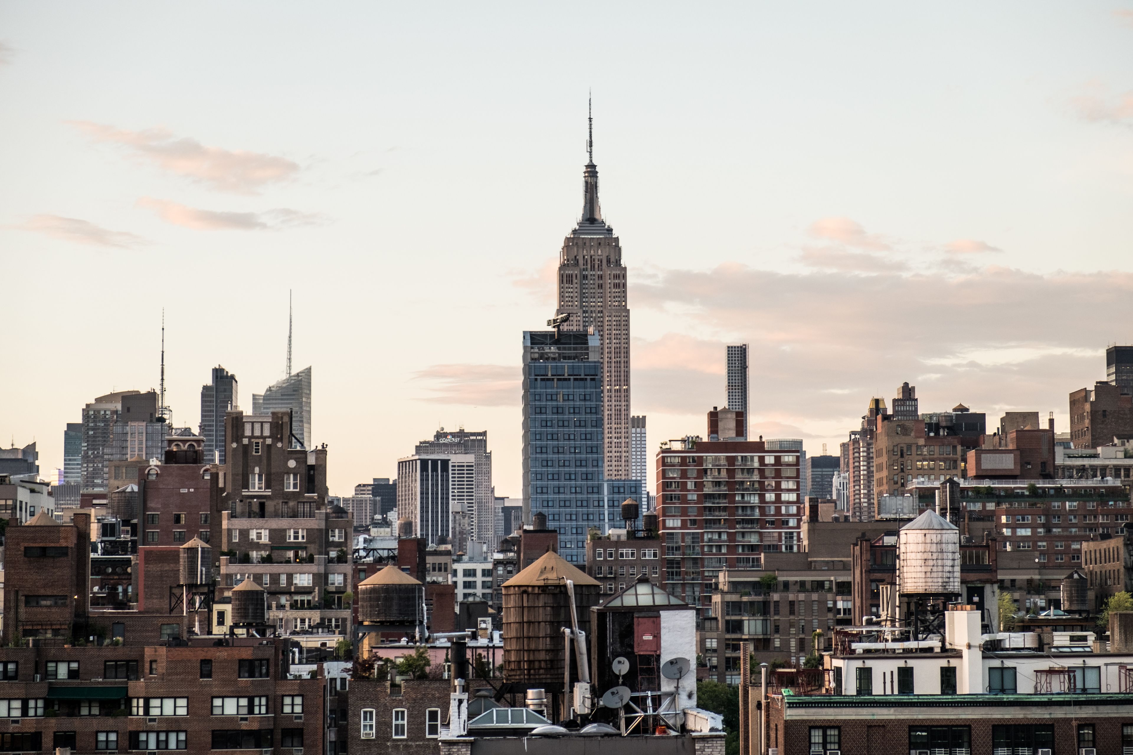 A cityscape with a prominent skyscraper in the center, surrounded by various buildings.