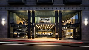 A modern building with a prominent entrance, large glass windows, and a sign reading "RADISSON COLLECTION". - Radisson Collection Grand Place Brussels (Brussels)