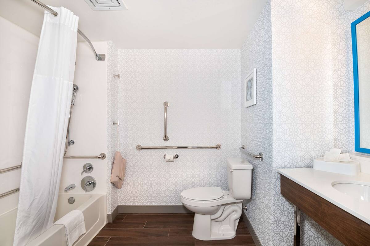 A bathroom with a bathtub, toilet, and sink.