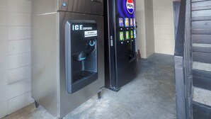 A vending machine and an ice dispenser in a hallway. - Motel 6 Greenwood, MS (Greenwood)