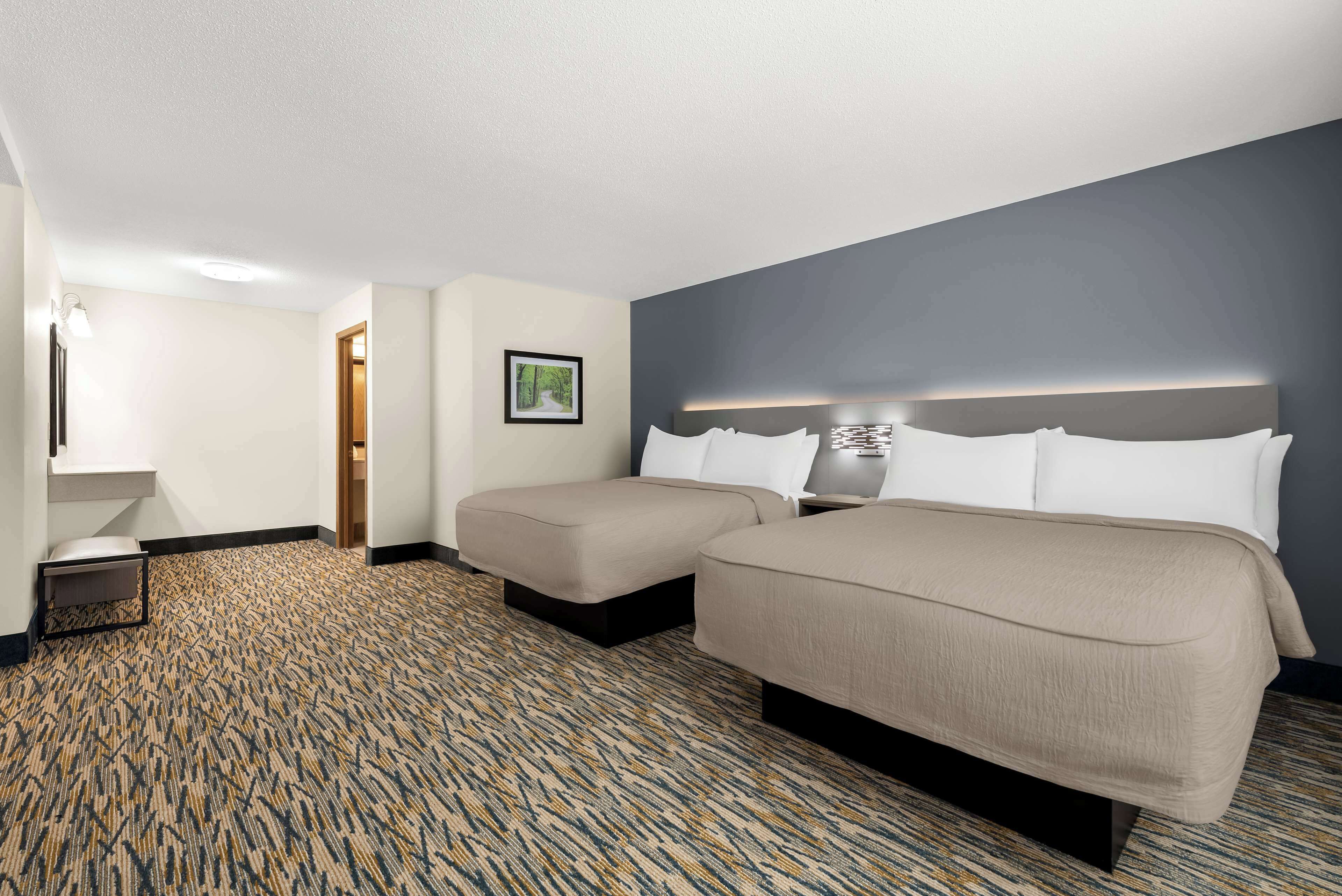 standard room, 2 queen beds, non smoking, refrigerator & microwave (larger room) | desk, iron/ironing board, free wifi, bed sheets