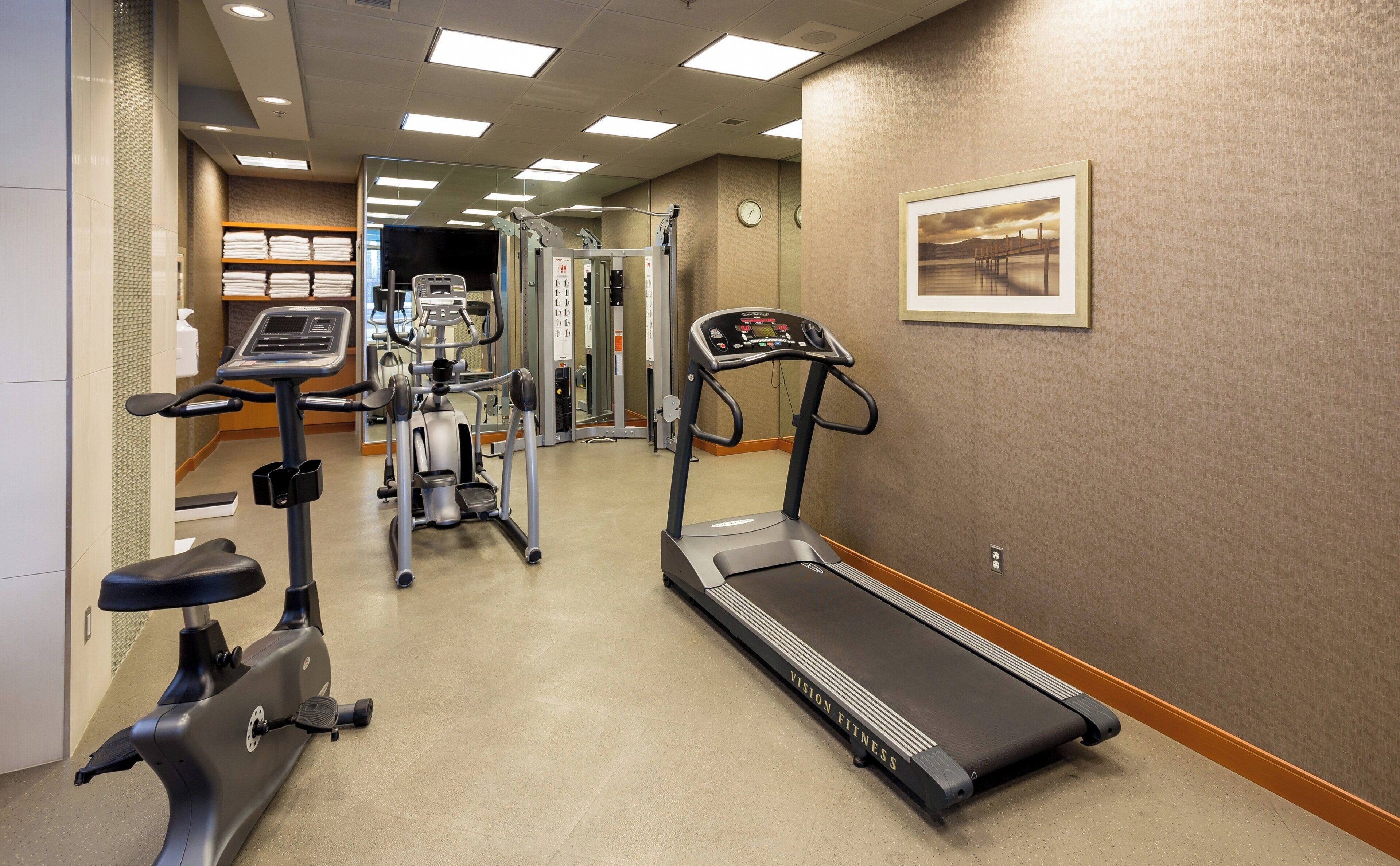 A gym with treadmills, an elliptical, and a stationary bike.