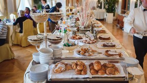 A buffet setup with various food items and serving dishes. - Grand Hotel Vesuvio (Naples)