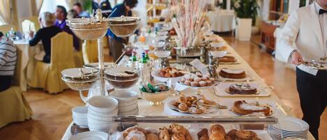 A buffet setup with various food items and serving dishes.