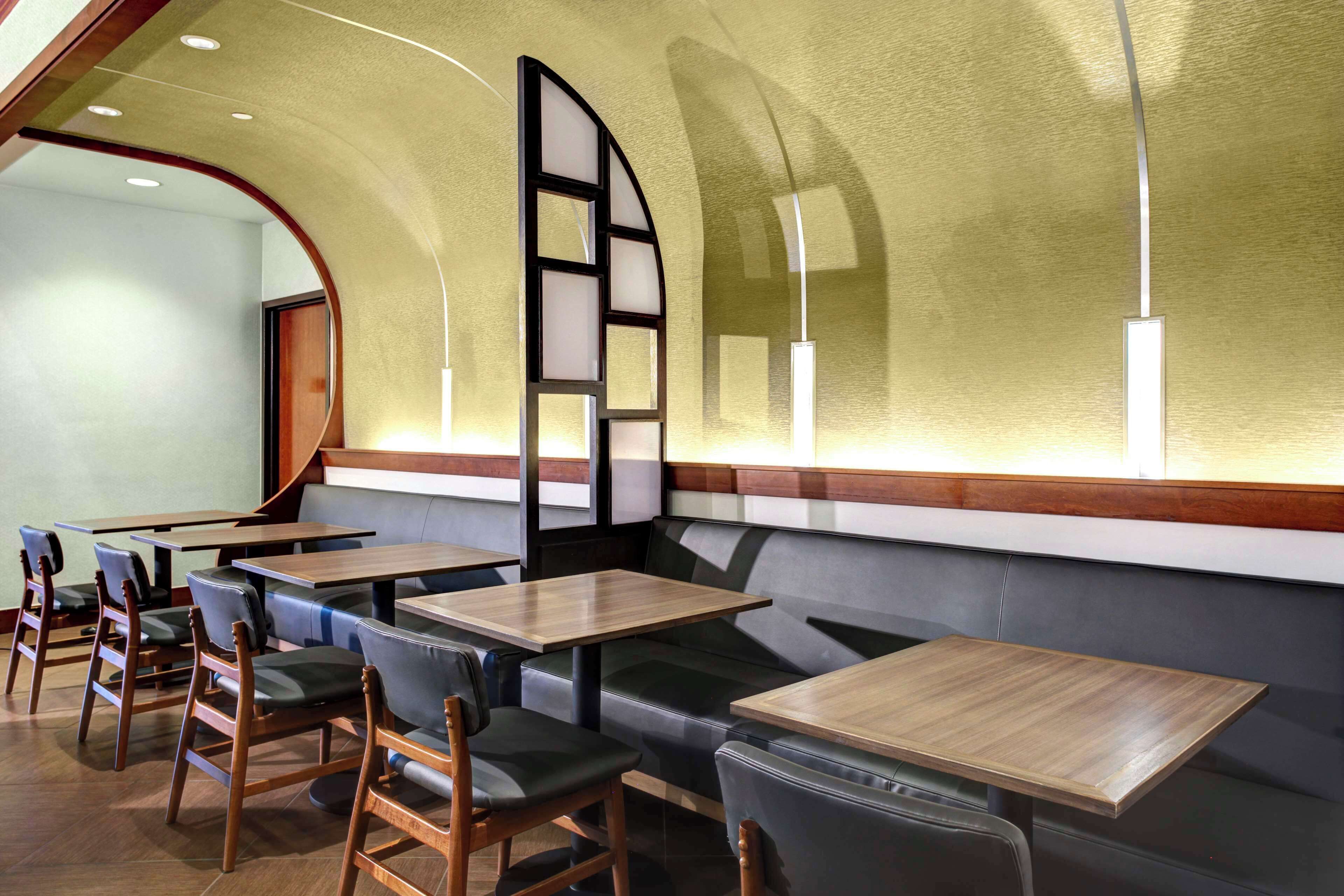 A restaurant interior with booths, tables, and chairs.