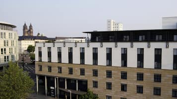 A multi-story building with a modern architectural design, featuring a mix of rectangular and square windows, and a flat roof.