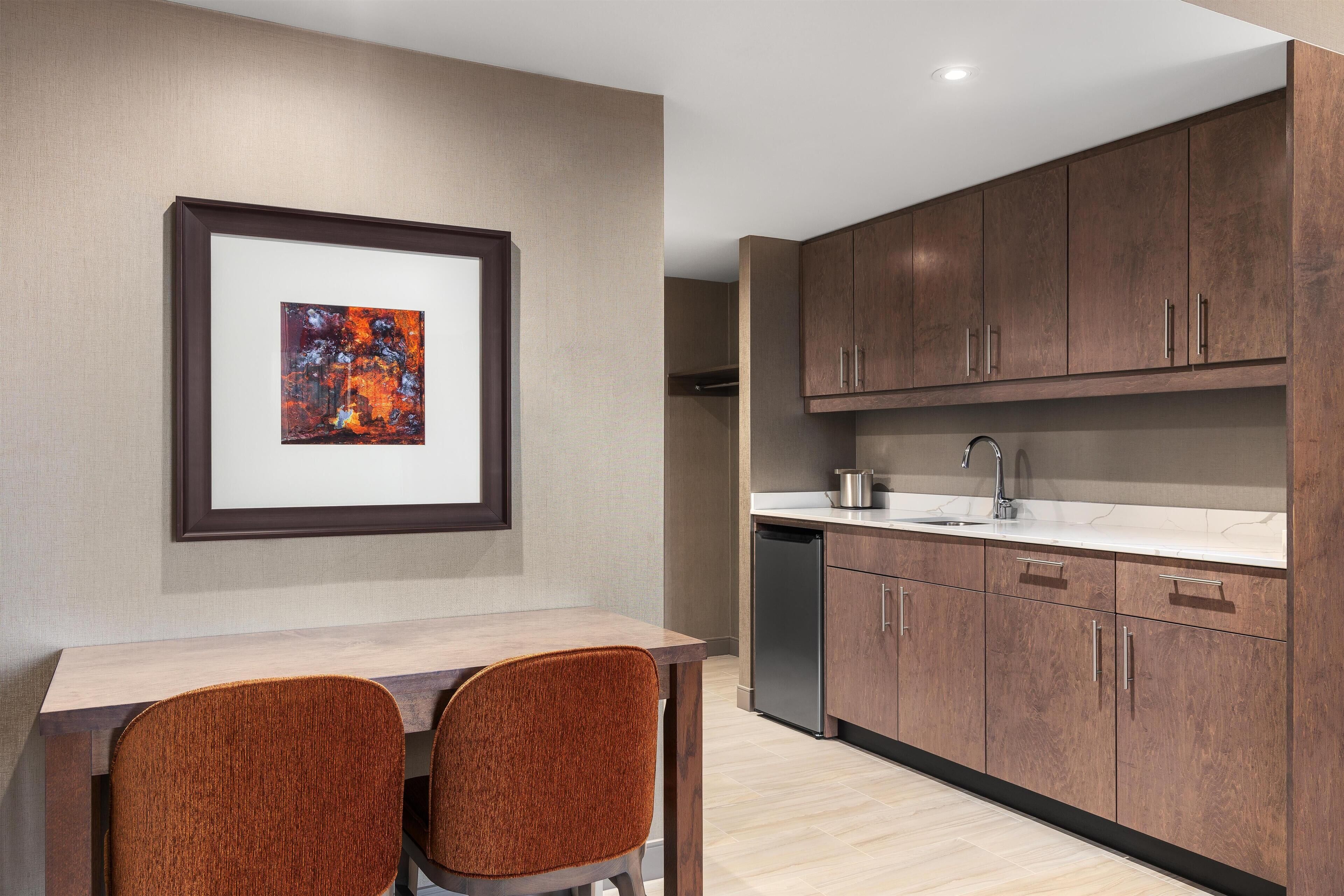 A modern kitchen with wooden cabinets, a stainless steel sink, and a dishwasher.