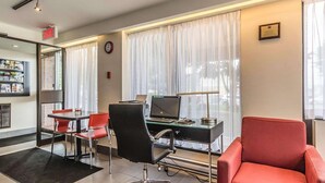 A modern office space with a desk, chairs, a laptop, and a bookshelf. - Comfort Inn Drummondville - Highway 20 (Drummondville)