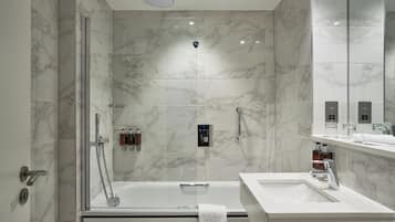 Ein modernes Badezimmer mit einer begehbaren Dusche, einer freistehenden Badewanne und einem Waschtisch.