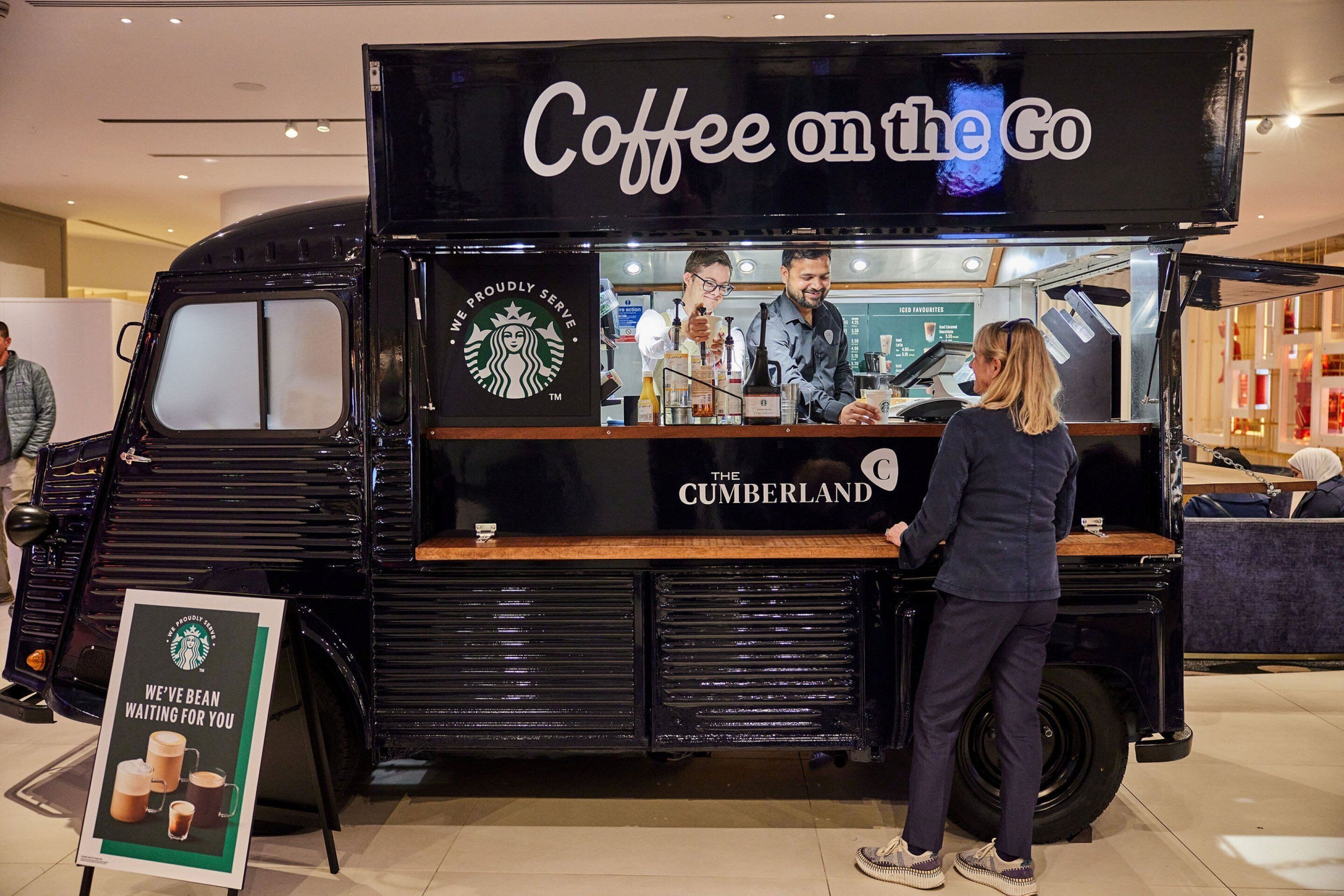 A mobile coffee truck with a sign reading "Coffee on the Go" and "The Cumberland".
