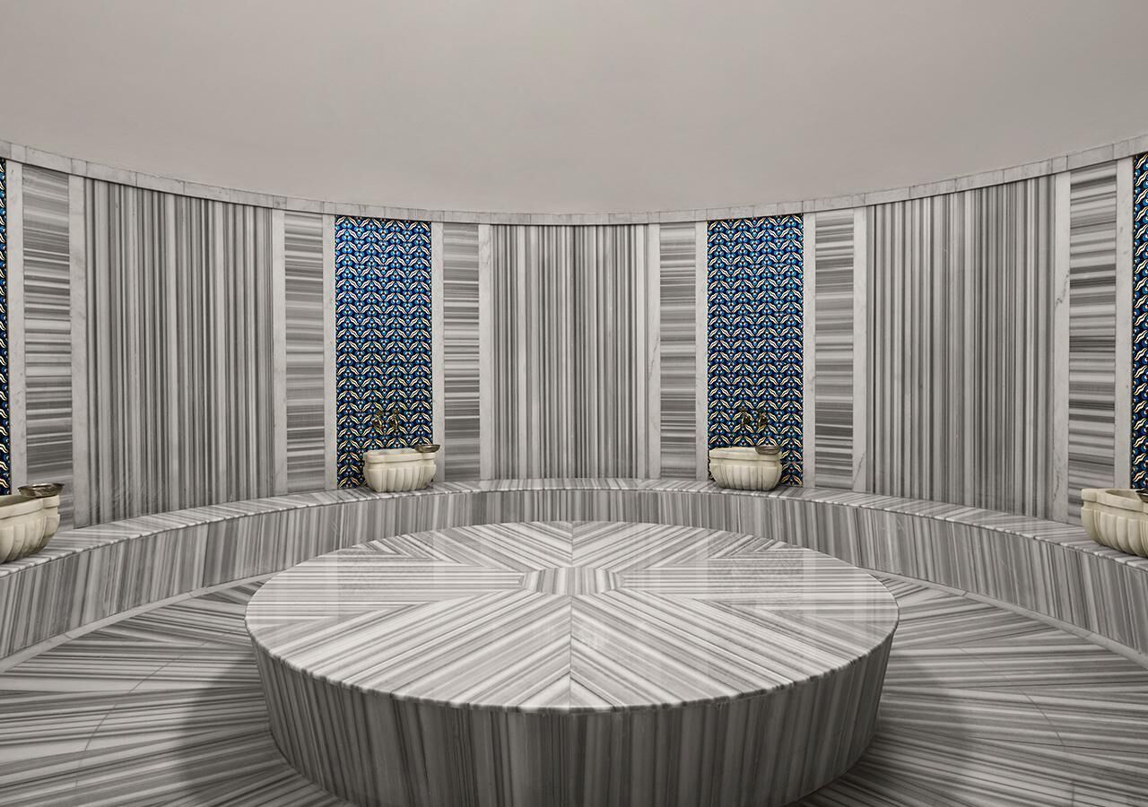 A circular conference room with a marble floor and walls, featuring a central table and four windows with patterned curtains.