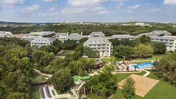 A resort with multiple buildings, a swimming pool, and a golf course.