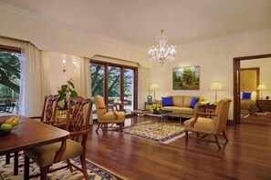 Deluxe Suite | Living room | 40-inch LED TV with satellite channels, TV, iPod dock