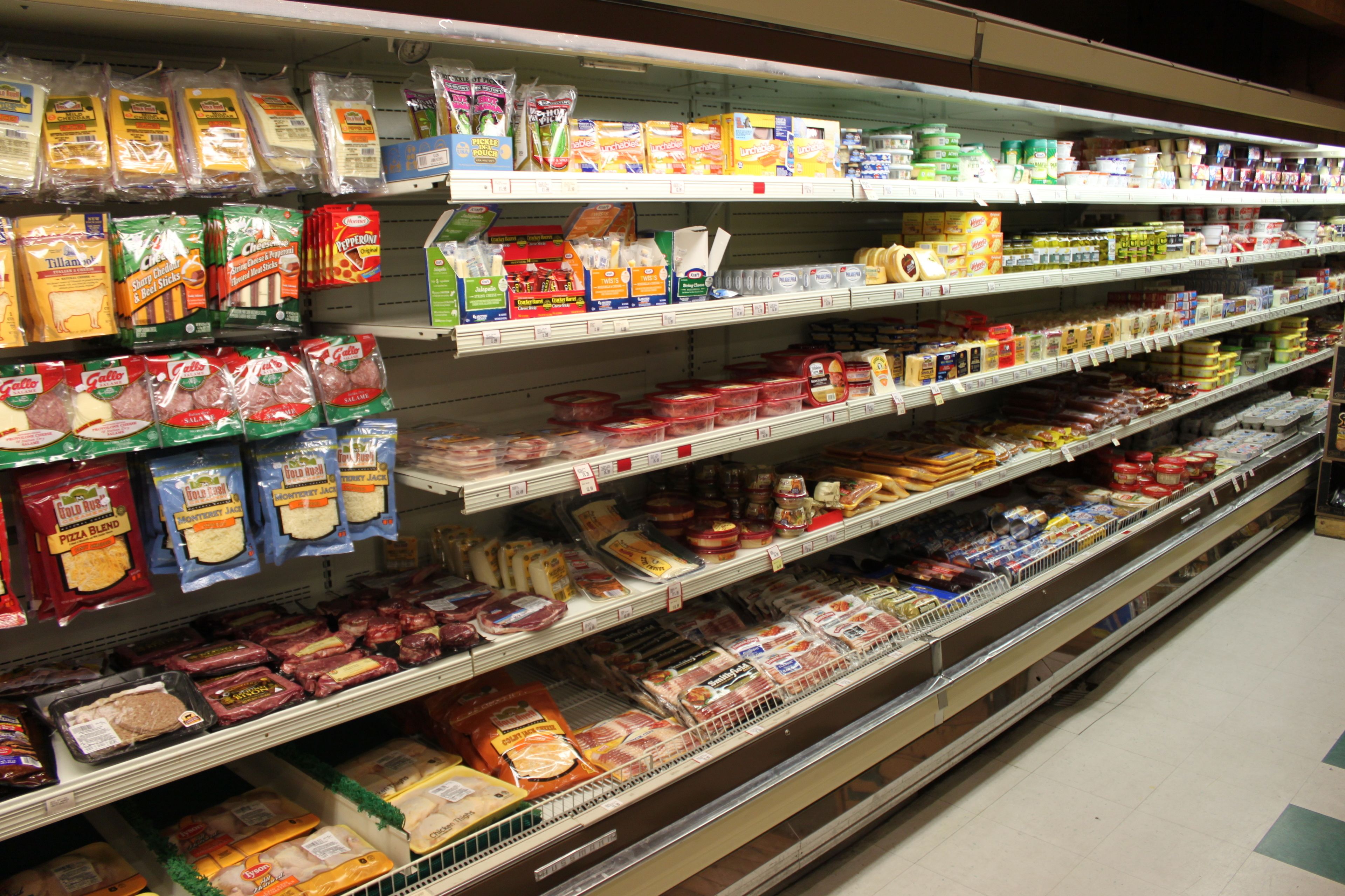 A grocery store aisle with various packaged food items on shelves.