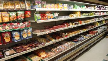 A grocery store aisle with various packaged food items on shelves.