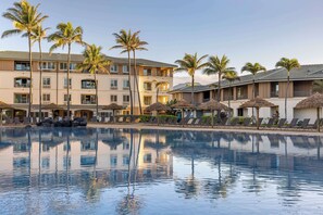 A resort with a swimming pool, palm trees, and multiple buildings with balconies. - Hilton Vacation Club The Point At Poipu Kauai (Koloa)