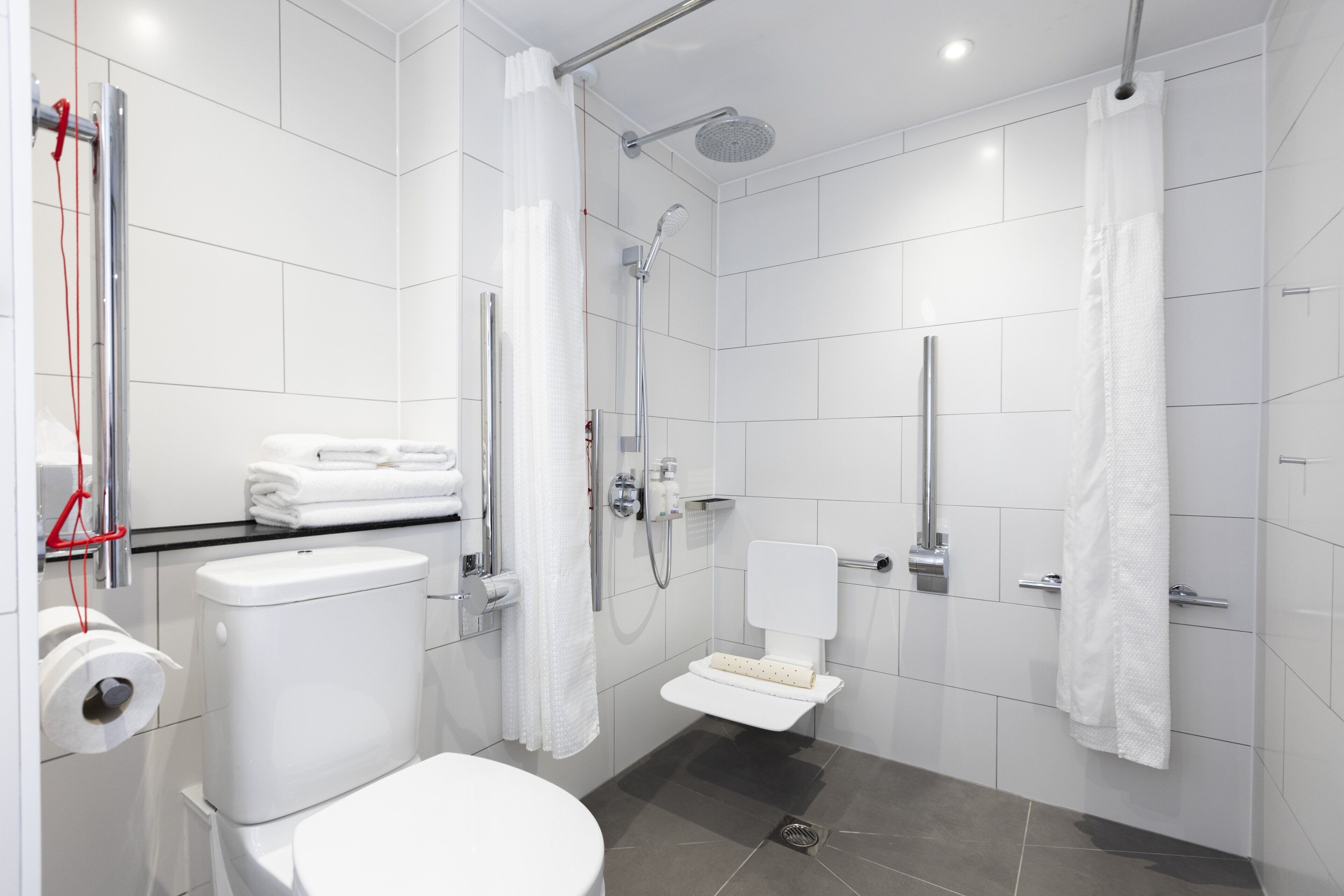 A modern bathroom with a toilet, bidet, and shower.