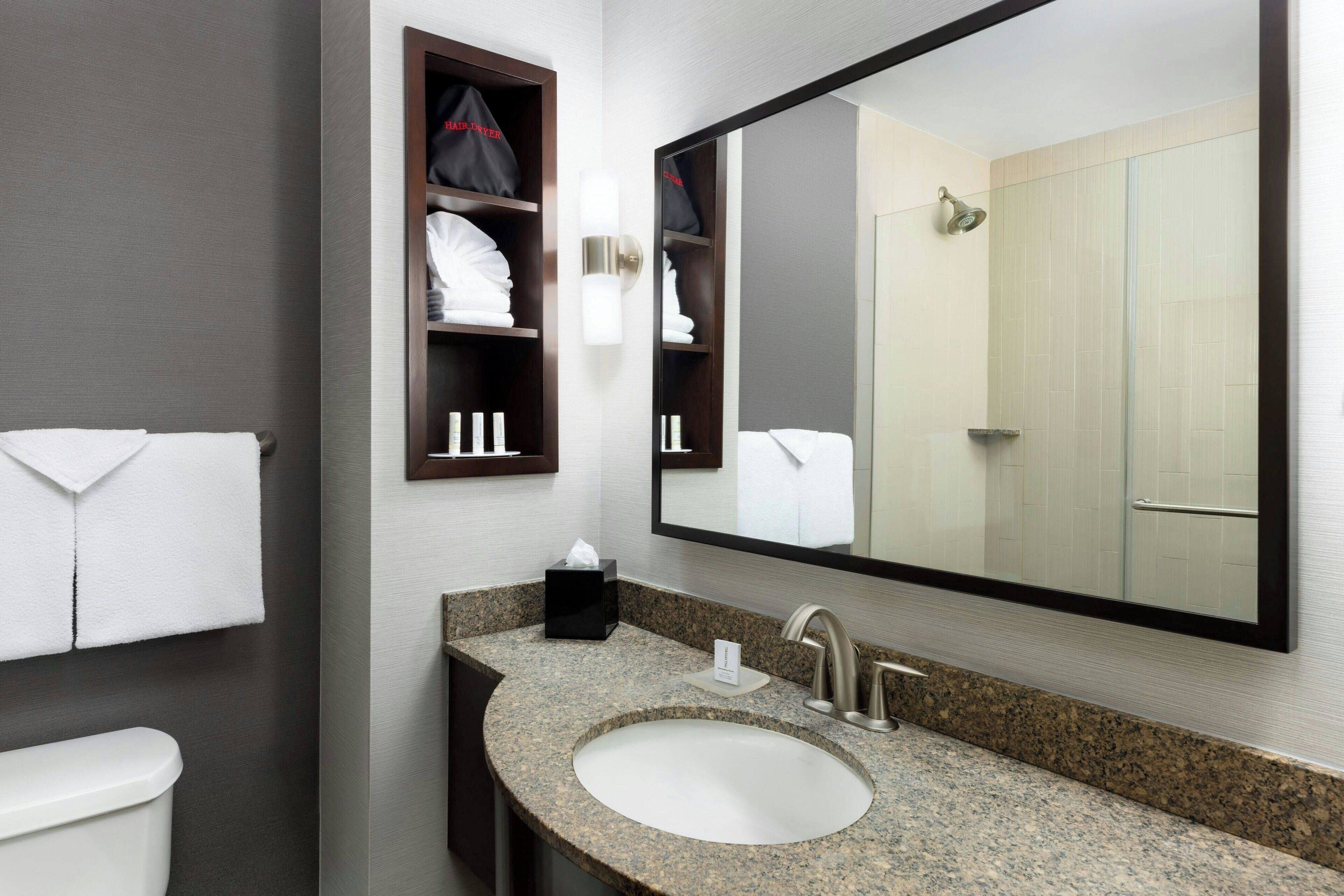 designer toiletries, hair dryer, towels, soap