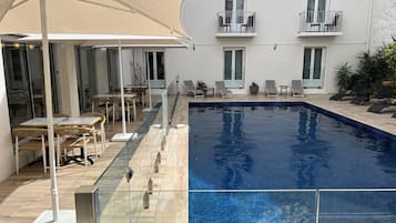 Seasonal outdoor pool, pool loungers