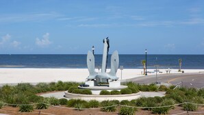 A sculpture of an anchor on a circular platform surrounded by greenery, overlooking a beach and the ocean. - Days Inn by Wyndham Gulfport (Gulfport)