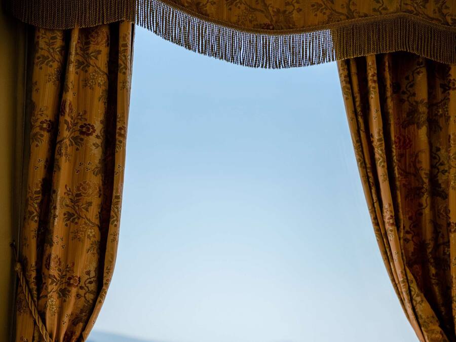 A table set for breakfast with a view of the sea.