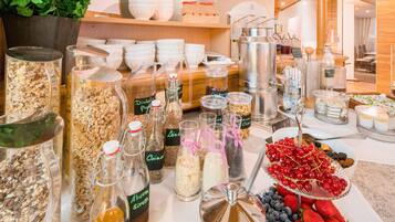 Uma mesa de buffet com diversos alimentos e acompanhamentos.