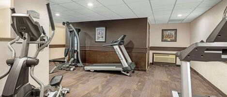 A gym with treadmills, ellipticals, and weight machines.