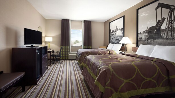A hotel room with two beds, a desk with a TV, a chair, a lamp, and a large window. - Super 8 by Wyndham Bakersfield South CA (Bakersfield)