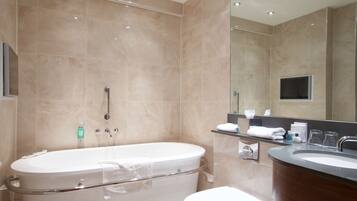 A modern bathroom with a freestanding bathtub, a toilet, and a vanity with a sink.