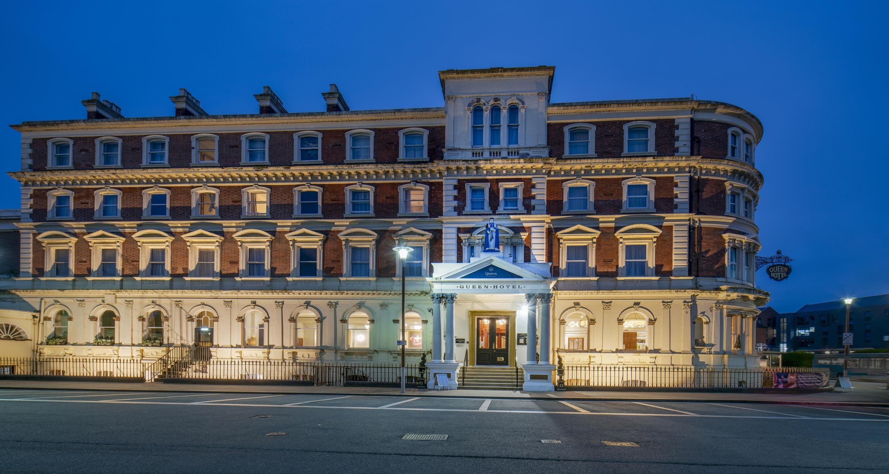 A historic hotel with a grand entrance, multiple stories, and classic architecture.