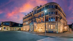 A historic building with multiple stories, large windows, and a classic architectural style. - The Queen at Chester Hotel - Handwritten Collection (Chester)