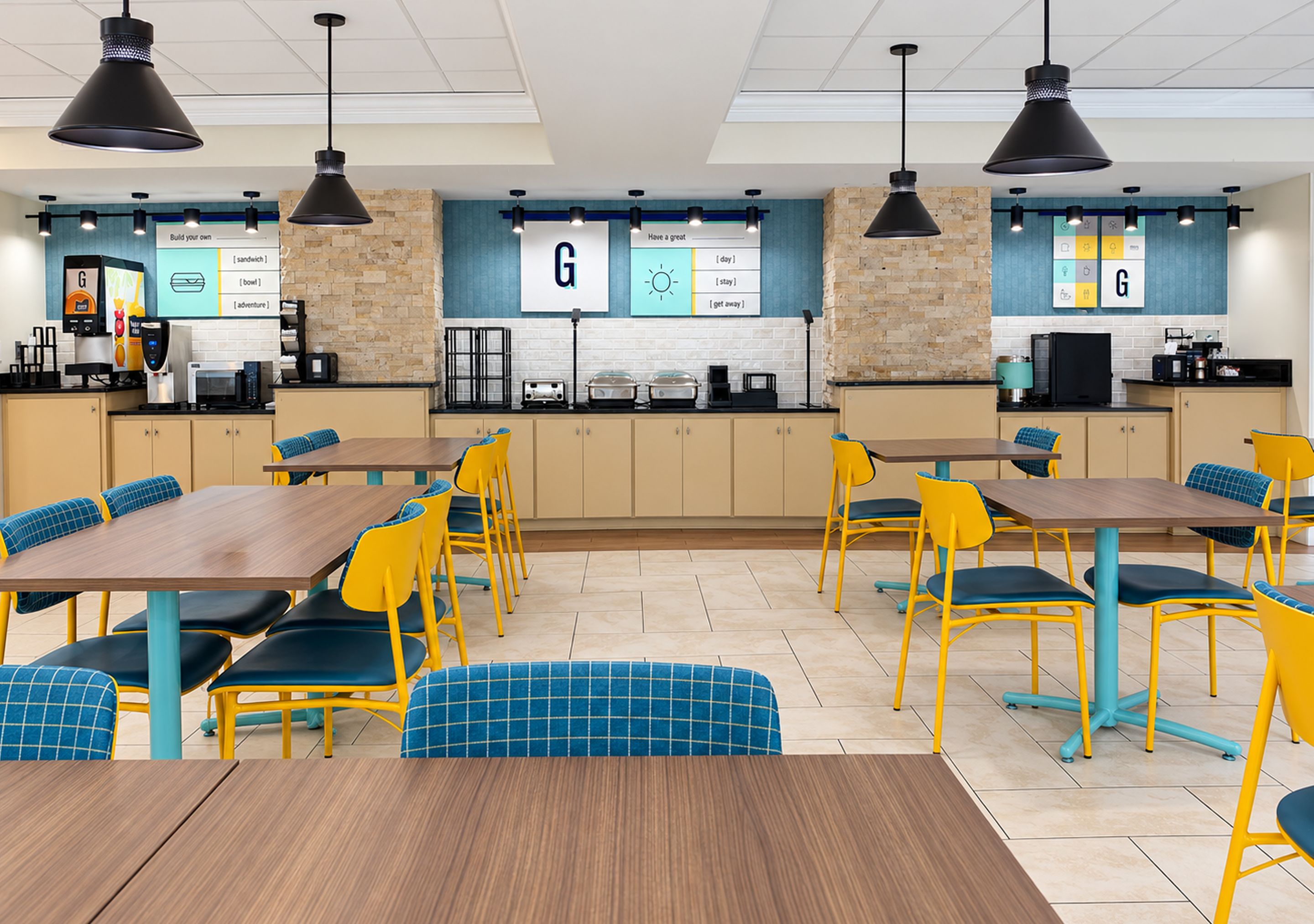 A cafeteria with tables and chairs, a coffee machine, and a menu board.
