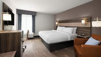 Premium bedding, desk, laptop workspace, blackout drapes