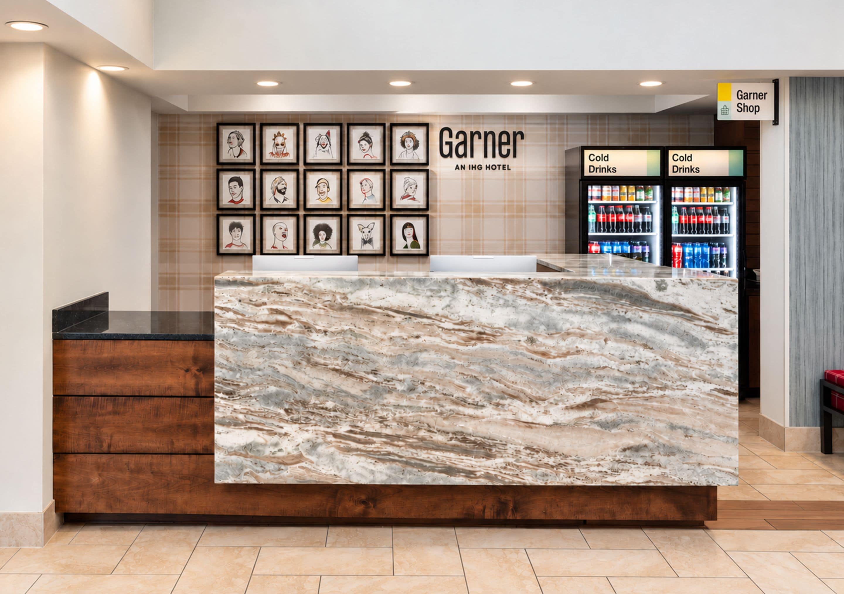 A hotel reception desk with a marble top, framed artwork on the wall, and a sign for the Garner Shop.