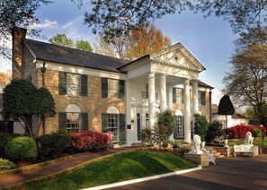 A large, historic stone building with a symmetrical facade, large windows, and a central entrance flanked by columns. - Courtyard by Marriott Memphis Airport (Memphis)
