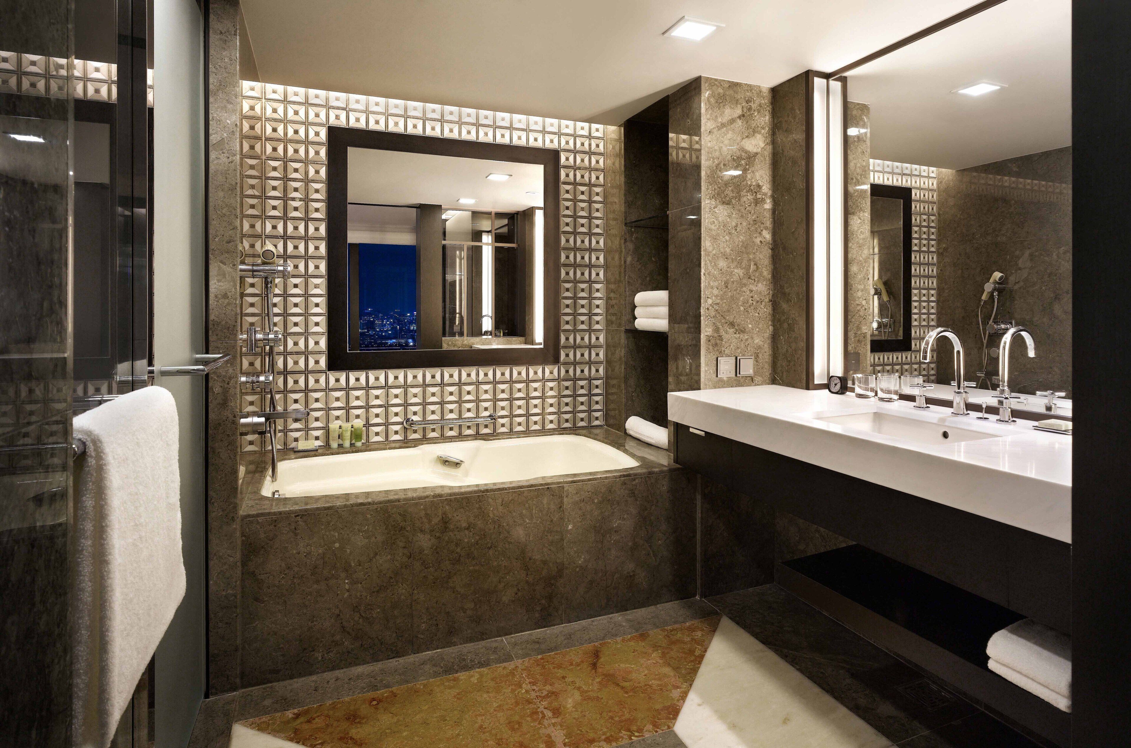 Grand Executive Suite King | Bathroom | Designer toiletries, hair dryer, bathrobes, slippers