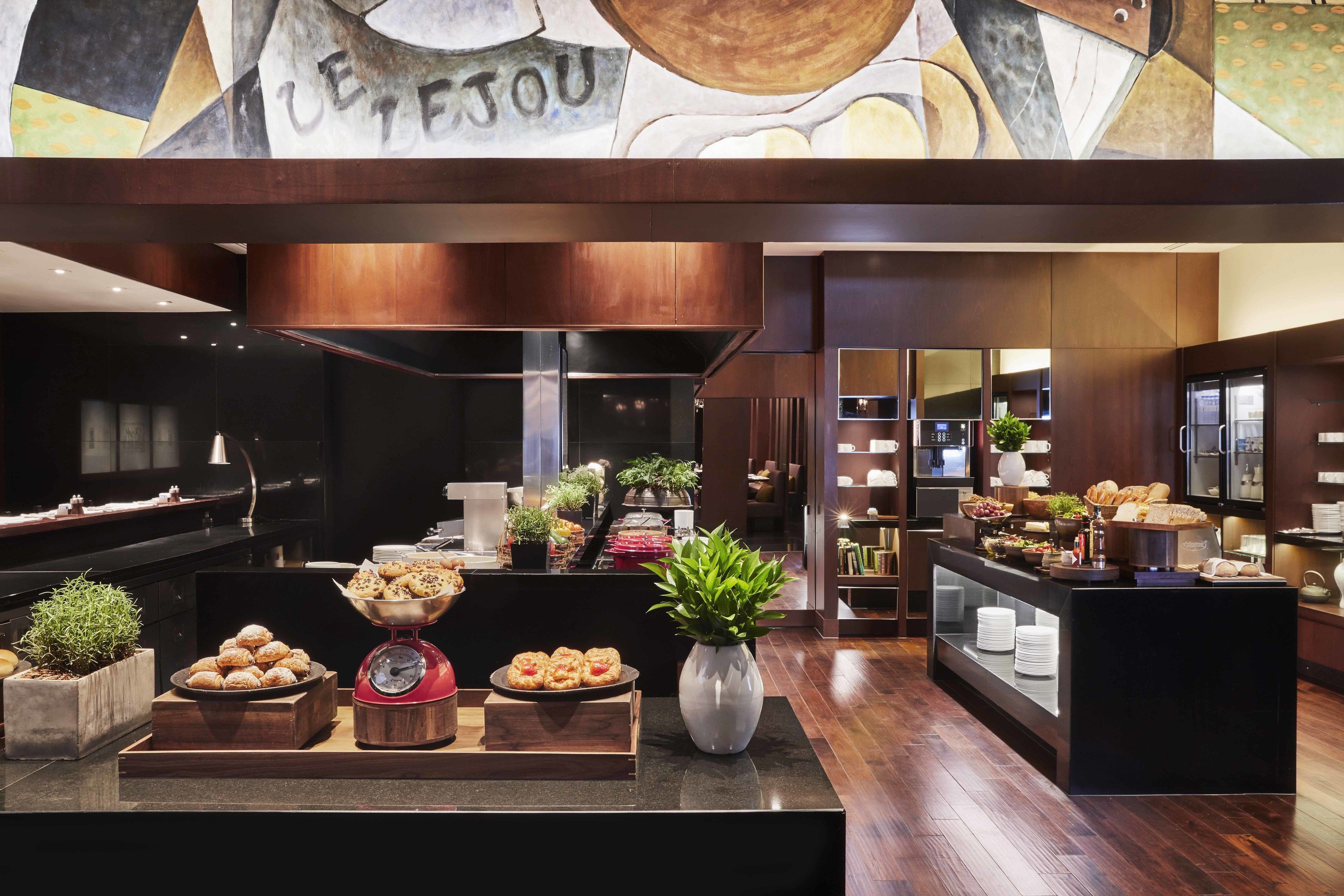 A buffet area with various food items and a clock.