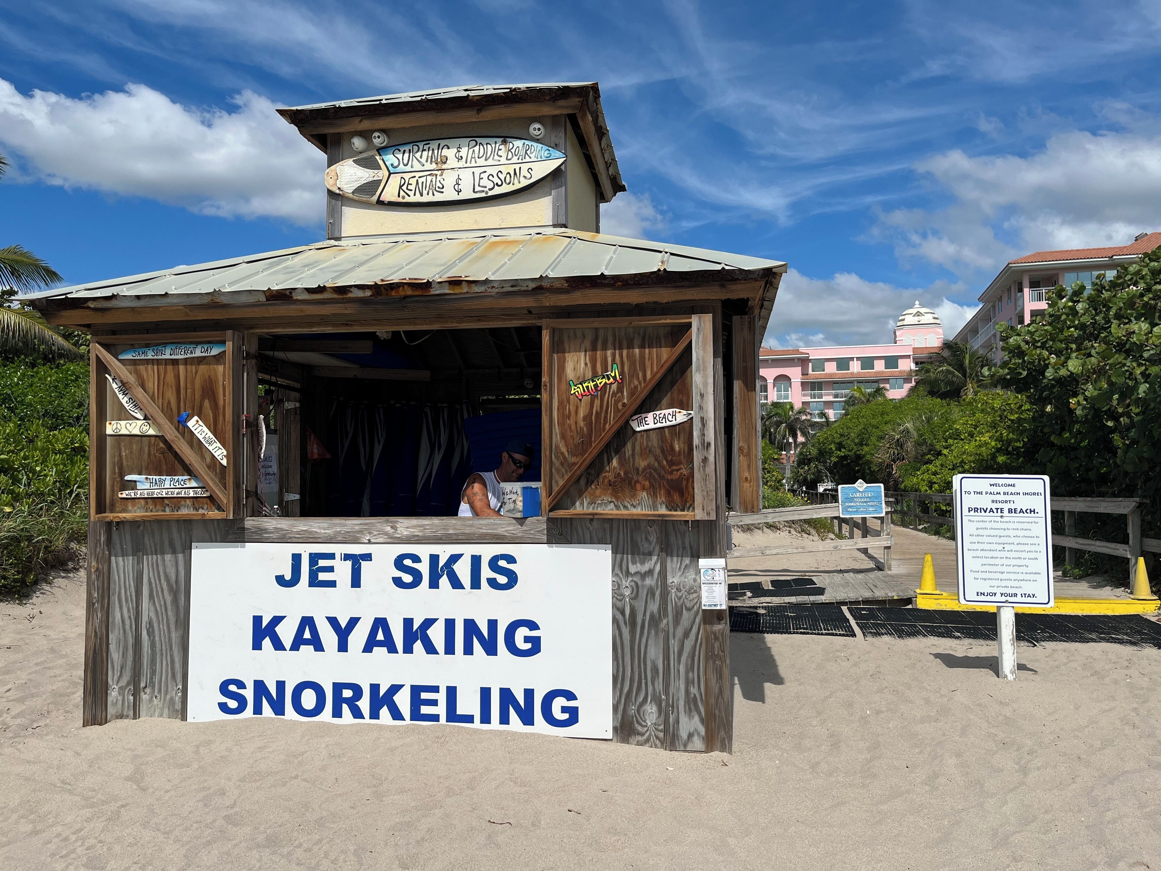 A wooden jet ski rental shack with a sign advertising jet ski, kayaking, and snorkeling services.