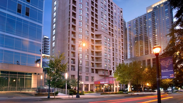 A multi-story hotel with a prominent 'Marriott' sign, large windows, and a well-lit entrance area.