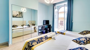 A hotel room with a large bed, a desk, a television, and a mirror. - Hotel Terminal (Rome)