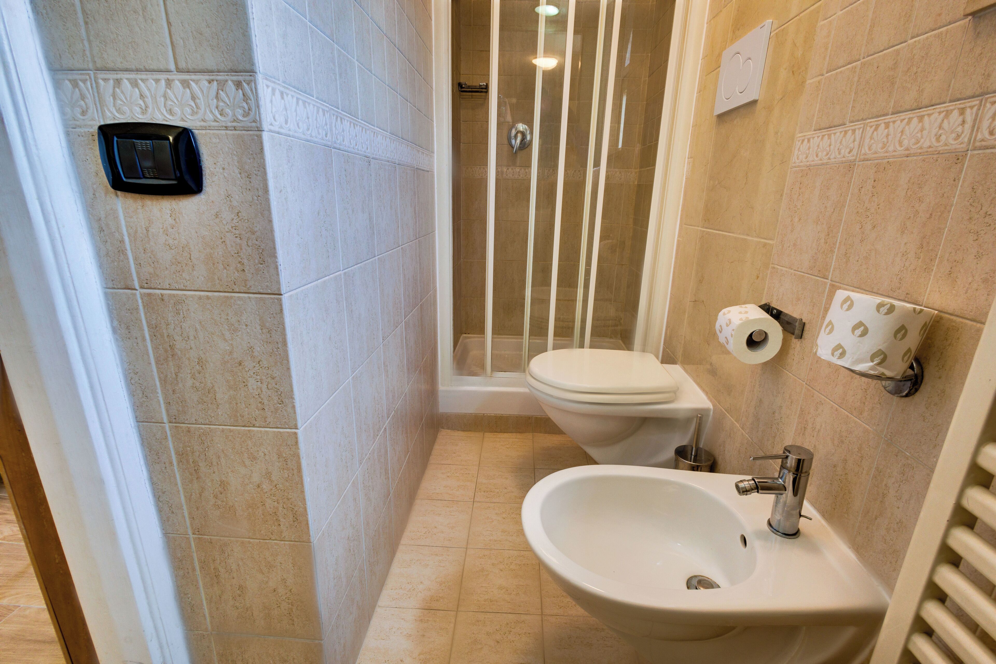 A bathroom with a shower, toilet, and sink.