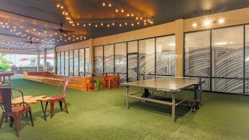 Relax and play in this vibrant indoor space with a ping pong table and cozy seating areas.